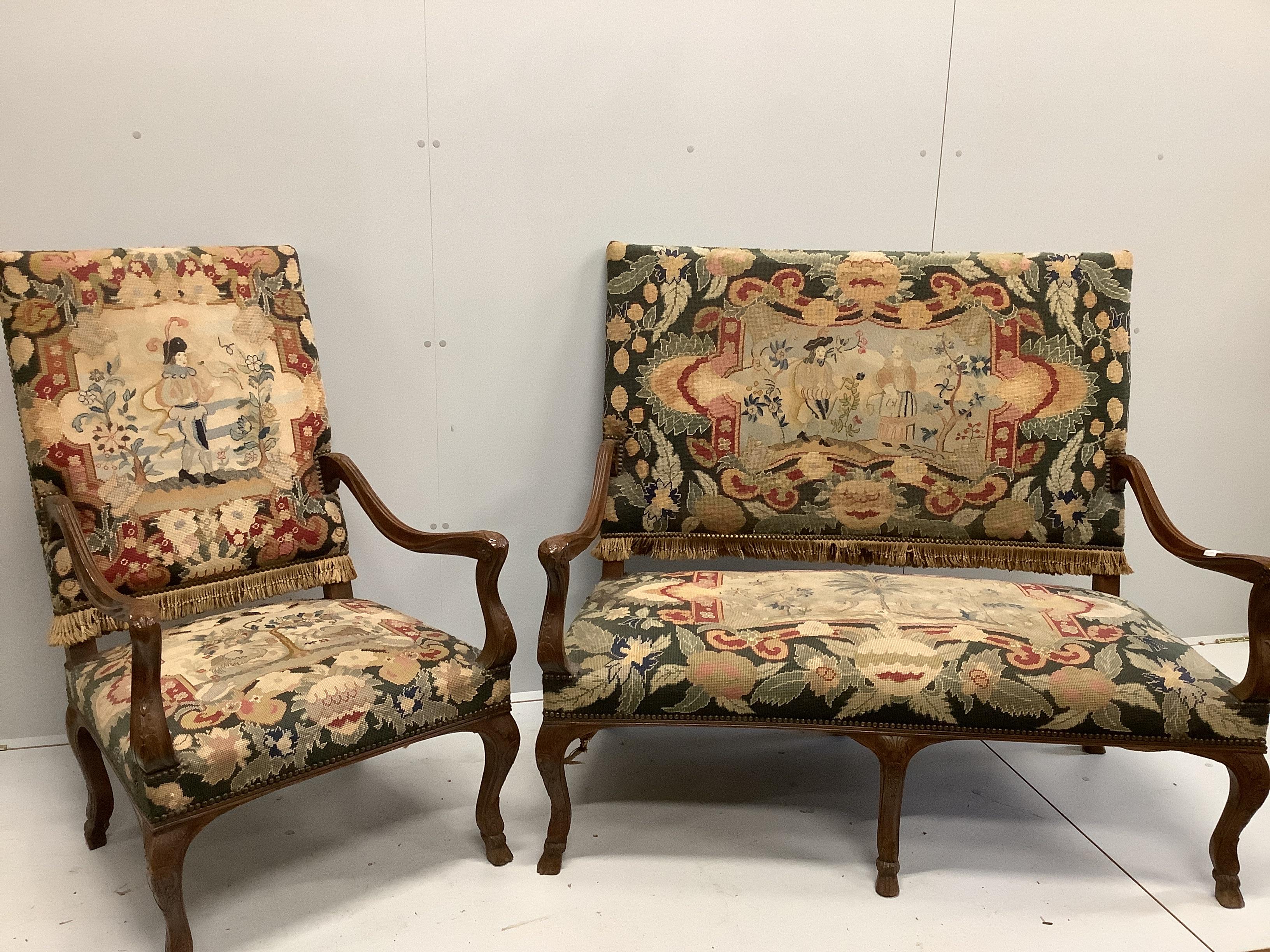 An 18th century style French upholstered walnut settee, length 116cm, width 66cm, height 112cm together with and a matching armchair